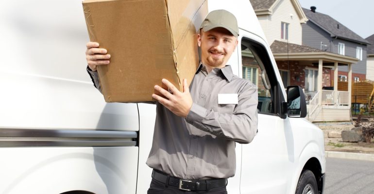 46629736 - young delivery man with parcel near cargo truck. shipping service.